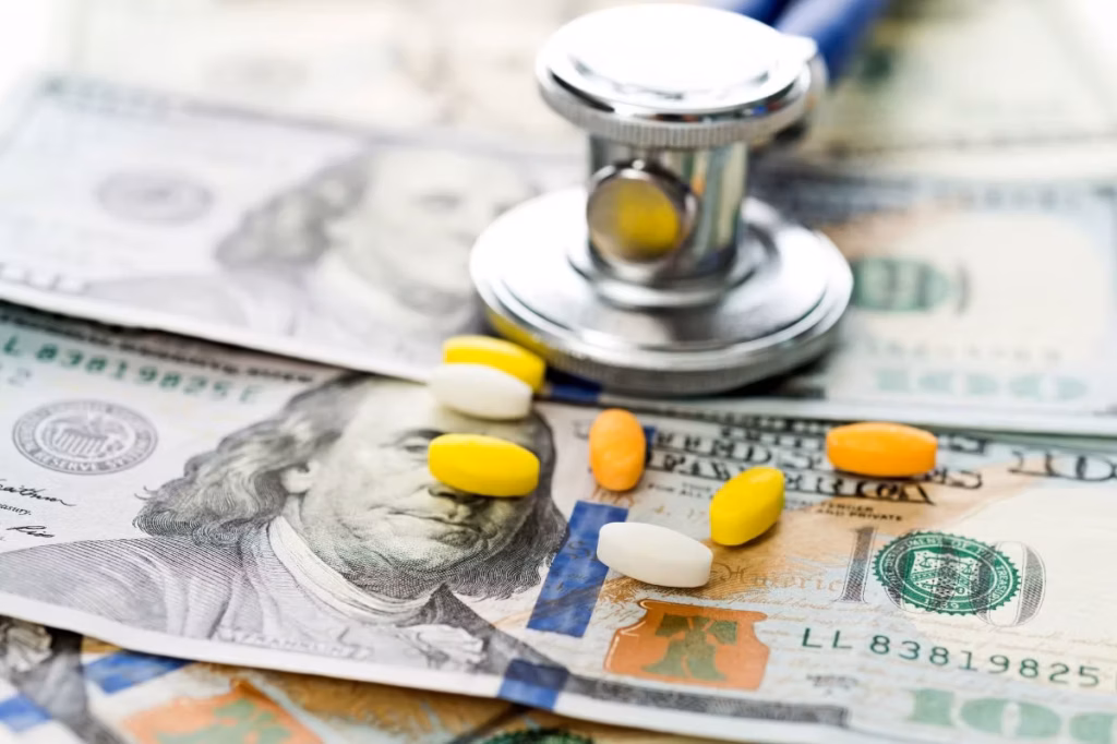 A picture of dollar bills with pills laying on top.