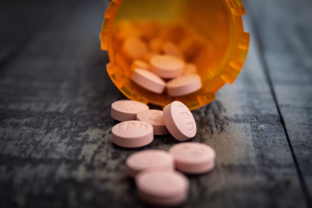 Pill bottle with pills spilling out.